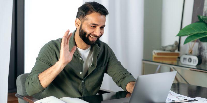 pleasant-friendly-indian-guy-manager-or-financial-consultant-communicates-with-colleagues-on-a.jpg